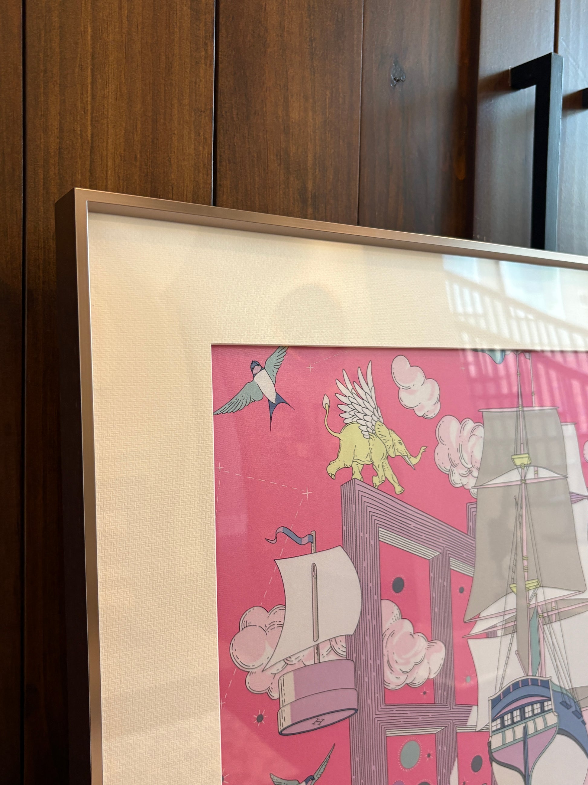 Silk scarf frame with couture purple gold matting displaying an Hermes silk scarf, wall-mounted for elegant presentation.